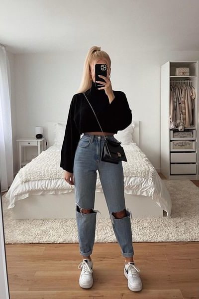 Black turtleneck with puffy sleeves and straight leg jeans