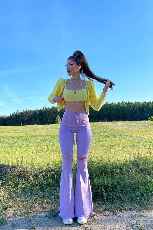 Girly outfits, pastel yellow cropped top with puffy sleeves and lavender flare jeans